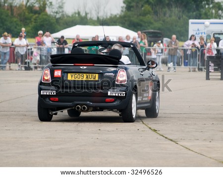 GRIMSBY, ENGLAND - JUNE 21: Stunt car driver Russ Swift entertains the crowds in his Mini Cooper at the New Mini Day, Manby Park,Grimsby in aid of Help For Heroes Charity, June 21st 2009