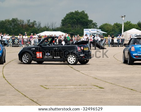 GRIMSBY, ENGLAND - JUNE 21: Stunt car driver Russ Swift entertains the crowds in his Mini Cooper at the New Mini Day, Manby Park,Grimsby in aid of Help For Heroes Charity, June 21st 2009