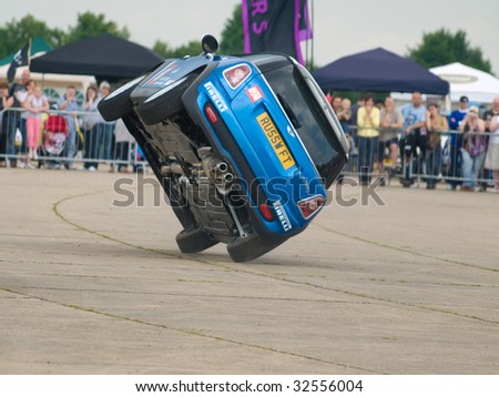 GRIMSBY, ENGLAND - JUNE 21: Stunt car driver Russ Swift entertains the crowds in his Mini Cooper at the New Mini Day, Manby Park,Grimsby in aid of Help For Heroes Charity, June 21 2009