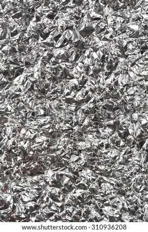 Silver wrinkled and shrunken foil surface, crinkly, crushed metallic background