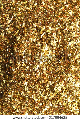 Blurred, Gold sand and dust texture. Golden sparkling glitter background. Metallic surface.