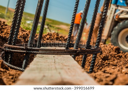 Steel rod used for poles construction with reinforce concrete in a hole in the ground at construction site.