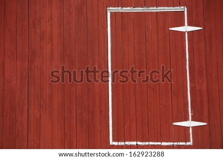 The side and door of an old red barn provides a nice, textured background for many design applications.