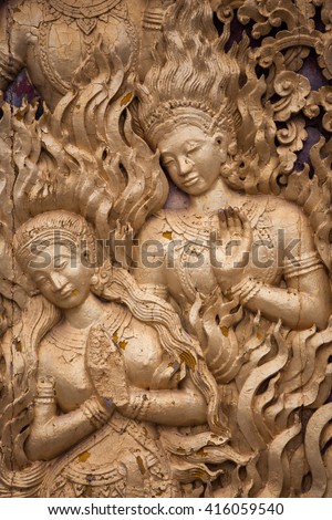 wooden mural in the temple of Laos