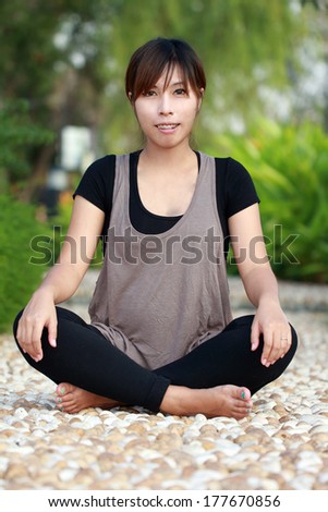 Asian girl sitting and feel good on the scree floor