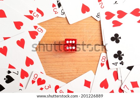 Poker cards and red dice in the center