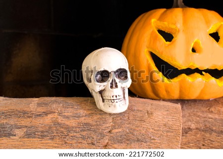 Halloween pumpkin and skull in a fireplace