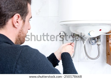 plumber fixing electric water heater