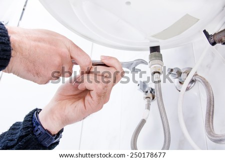 plumber fixing electric water heater