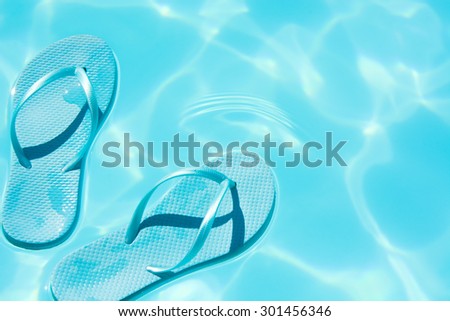 summer shoes afloat in the swimming pool
