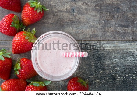 Strawberry smoothie on rustic wood