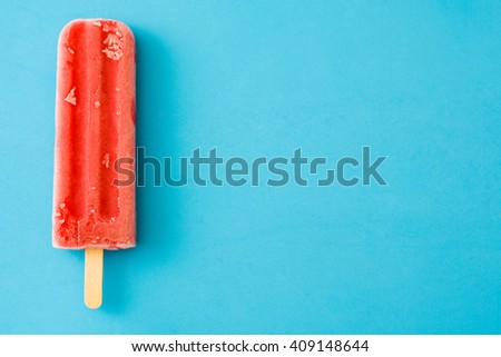 Strawberry popsicle. Blue background