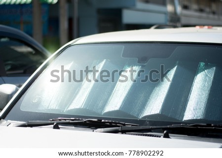 sun shade or sun reflector on the windshield the car Protection of the car in a parking. have the light from the sun shines to the windshield