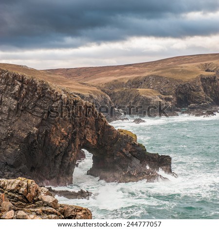 Natural Archway on Scottish coastline,A stormy day on north Scottish coast line at Strathy Point