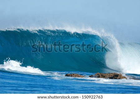 A Beautiful Blue Wave Crashes Into The Rocks At Inhaca Island, Mozambique.