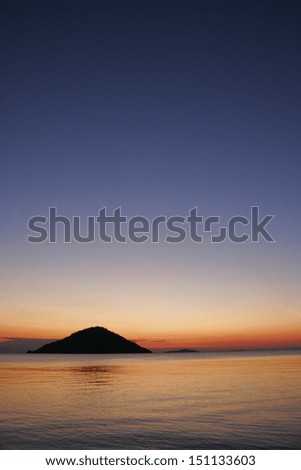 The sun sets over the waters and islands of Lake Malawi, Malawi, Africa.