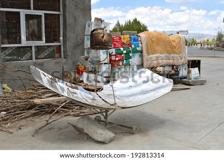 Shegar, Tibet, China - 9 May 2014: A kettle sits above a reflective sun dish, being heat by concentrated solar energy being reflected onto the bottom of the kettle to boil the water inside.