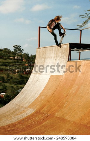 A skateboarder executes a radical move on a wooden half-pipe in Inanda Valley, KwaZulu-Natal, South Africa.