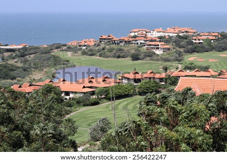 Houses line a golf course at an upmarket seaside housing estate.