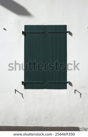 Wooden window shutters - Closed green shuttered wooden window in the Basque Country, France.