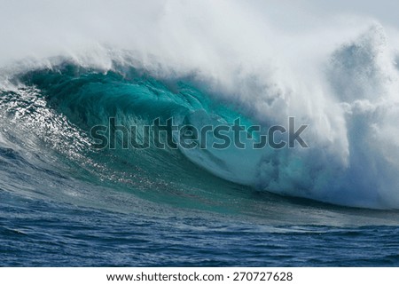 A beautiful blue wave crashes down at one of the world\'s premier big wave surfing spots, Dungeons in Cape Town, South Africa.