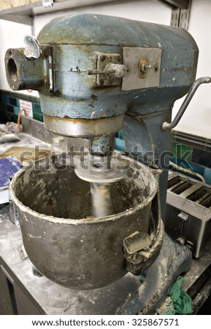 An industrial dough mixer in an artisanal bakery.