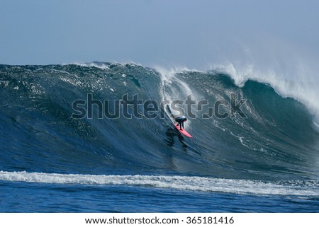 A surfer rides a huge wave at Dungeons in Cape Town, South Africa.