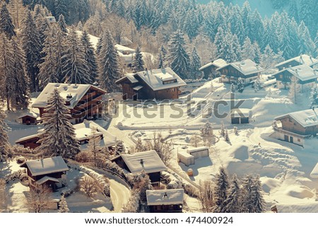 A quaint village in the Swiss Alps during winter. Added vintage filter.