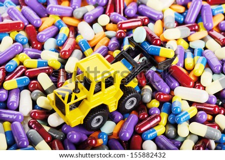 Industrial loader tractor toy load pills and tablets (Installation on the theme of modern medicine)