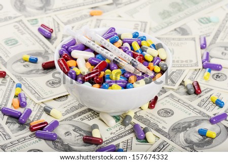 Plate full of tablets, pills and syringes (installation on the theme of modern medicine trends)