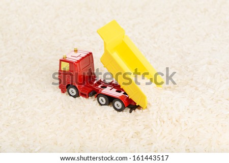 Dump truck toy unload rice grains (installation on the theme of agriculture business)