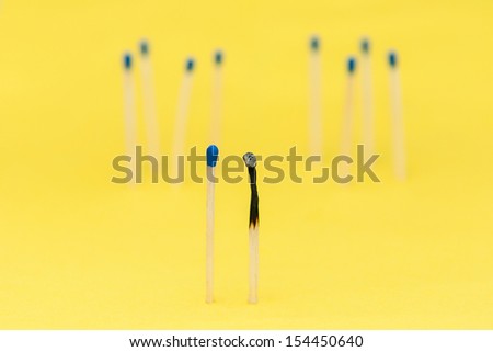 Love against all odds - matches against yellow background close up
