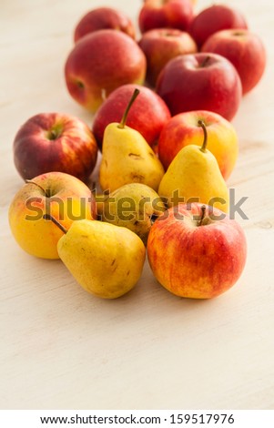 Fresh apples and pears laying on the table