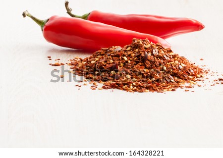 Flaked chili pepper close up and red bean pods