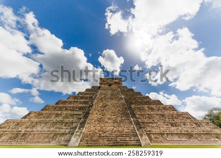 Maya pyramid with sky clouds and sun