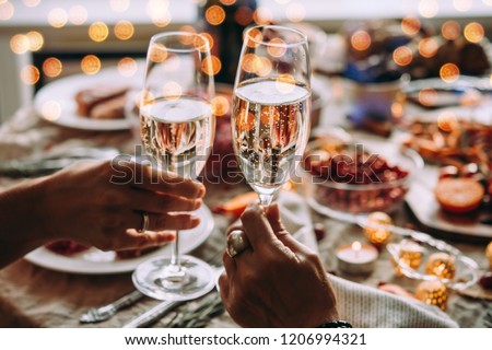 Party table with glasses of champagne. Friends celebrating Christmas or New Year eve.