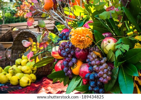 Autumn harvest bouquet of flowers and fruits