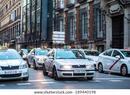 MADRID, SPAIN - MARCH 12: Old narrow street with taxi cabs in March 12, 2014 in Madrid, Spain. It is old centre of capital city