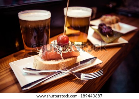 Pinchos or pintxos, traditional Basque Country appetizer. Served with beer