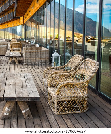Rattan chairs and table on terrace in mountains