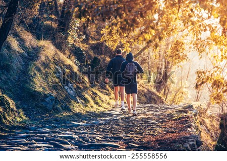 Two men running in forest