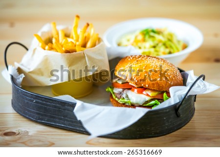 Lunch menu with classic american cheese burger, french fries and vegetable salad