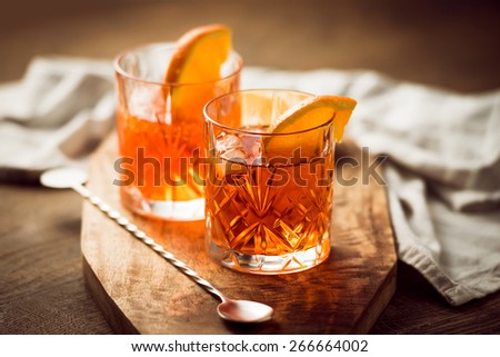 Two glasses of cocktail with orange slice