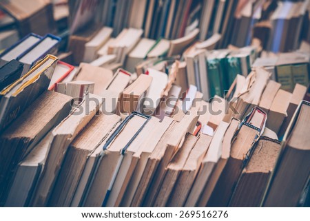 Many old books in a book shop or library. Toned image. Shallow DOF