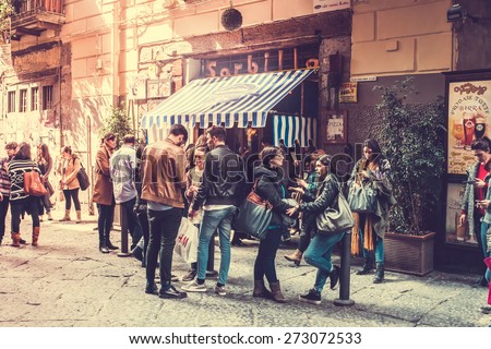 NAPLES, ITALY - MARCH 20, 2015: People standing and waiting near the famous pizzeria Gino Sorbillo in the historical center of Naples, Italy. Toned picture