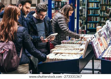 NAPLES, ITALY - MARCH 20, 2015: People looking around in the second hand book stalls of the book market in the historical center of Naples, Italy