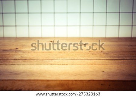 Empty kitchen wooden table and white tile background. Perfect for product montage. Selective focus