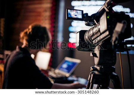 Filming creative video footage with professional video camera during the night