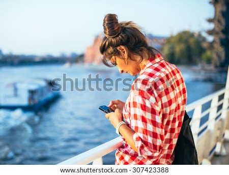MOSCOW, RUSSIA - AUGUST 9, 2015: Young woman is checking her smartphone on board of Brusov ship in Moscow, Russia. Brusov ship is a new nightclub on board of vintage Valery Brusov cruise ship.
