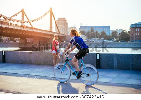 MOSCOW, RUSSIA - AUGUST 9, 2015: People are riding bicycles in Muzeon park near Krymsky (Crimean) bridge at sunset in Moscow, Russia. Toned image